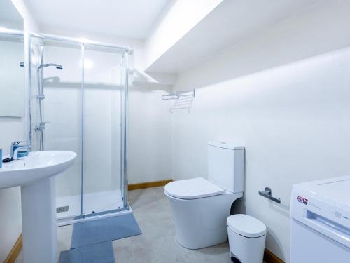 a bathroom with a shower and a toilet and a sink at Cute Las Flores 1i with pool in Costa de Adeje