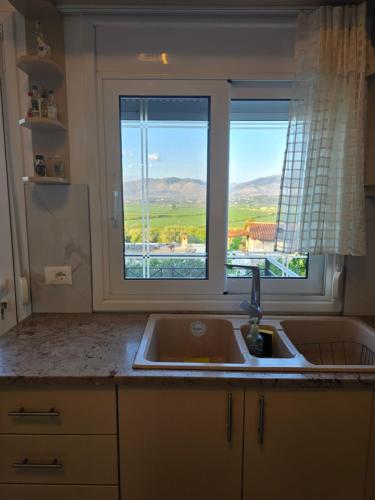 a kitchen with a sink and a window at Villa Nefeli in Sarandë