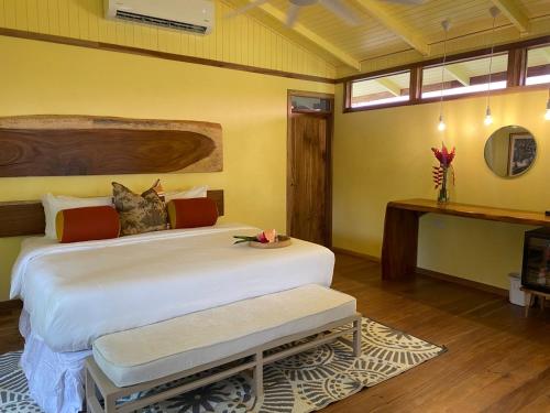 a bedroom with a large white bed in a room at Mawamba Lodge in Tortuguero