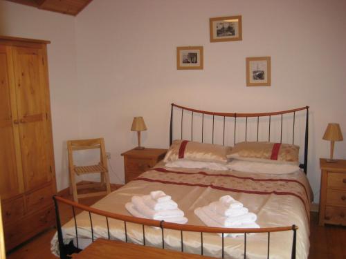 a bedroom with a bed with towels on it at Fishers Croft in Hamnavoe