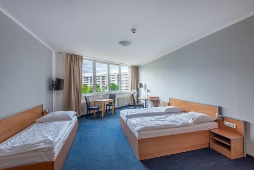 Hotel Sedes Berlin tesisinde bir odada yatak veya yataklar