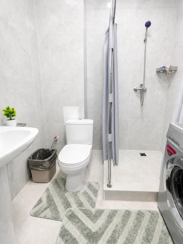 a bathroom with a toilet and a sink and a shower at Saltanat hotel in Alghabas