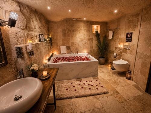 a large bathroom with a tub and a sink at Hira Cave Hotel in Göreme