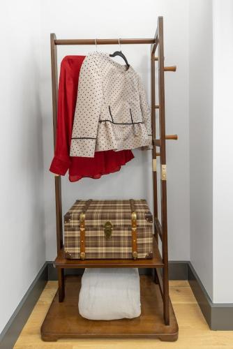 a shelf with a sweater and a suitcase on it at Harvard Charm Near Boston New build in Cambridge