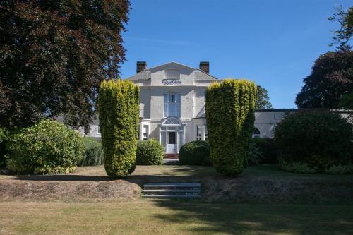 a large white house with trees in front of it at Best Western The Royal Chase Hotel in Shaftesbury