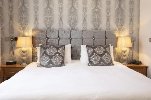 a bedroom with a large white bed with two lamps at Best Western The Royal Chase Hotel in Shaftesbury