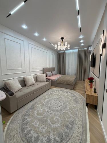 a large living room with a couch and a table at Жк Prime Park 2 in Shymkent