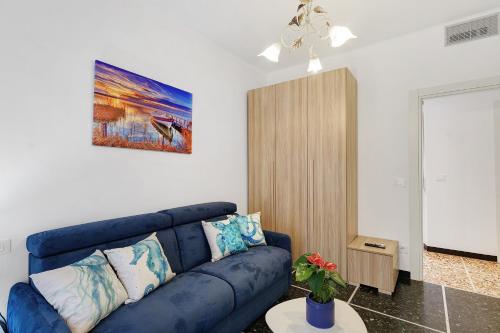 a living room with a blue couch in a room at Casa Antonio in Alassio