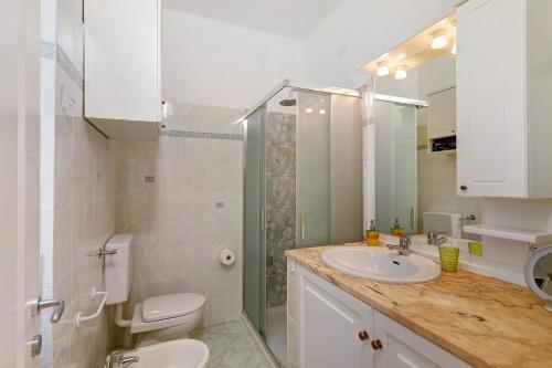 a bathroom with a sink and a toilet and a shower at Casa Antonio in Alassio