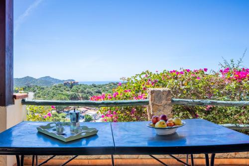 a blue table with a bowl of fruit on it at Il Fortino Sea View in Geremèas