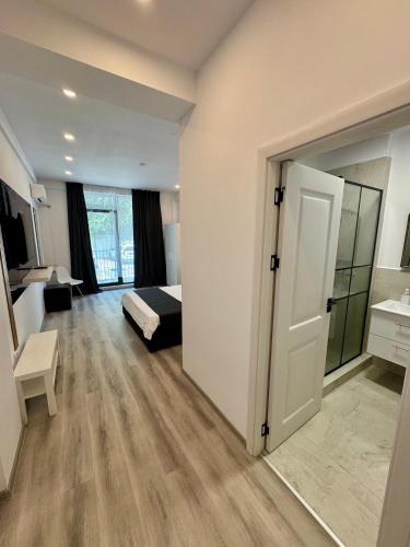 a bedroom with a bed and a door to a room at Mimar Boutique in Eforie Sud