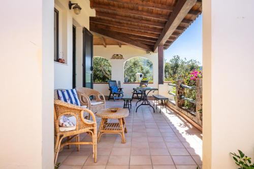 a patio with chairs and tables and a table at Il Fortino Sea View in Geremèas