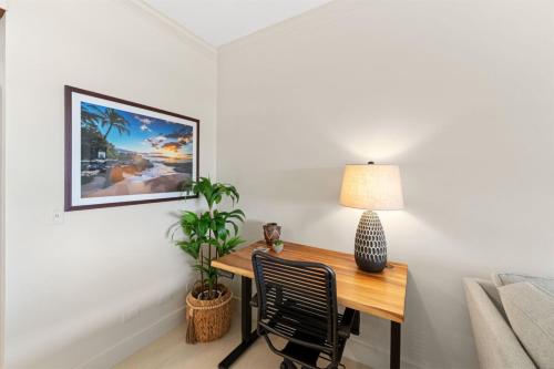 a room with a desk with a lamp and a chair at 1712 Kapalua Home in Kahana