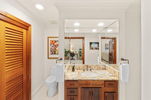 a bathroom with a sink and a mirror at 1712 Kapalua Home in Kahana