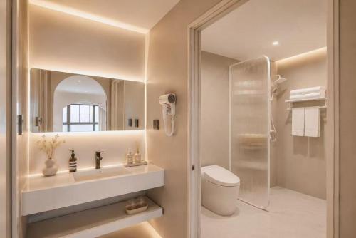 a bathroom with a sink and a toilet and a mirror at Lucky Designer Residence Near Bell Tower & City Wall in Xi'an
