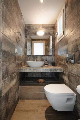 a bathroom with a sink and a toilet at Passa Corda Villa in Agios Prokopios