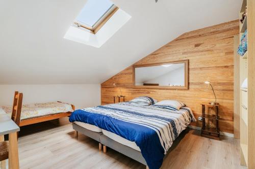 a bedroom with a bed and a mirror on the wall at Gites de l'hivet in Merdrignac