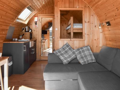 a living room with a couch in a tiny house at Stainton-Uk1395 in Corney
