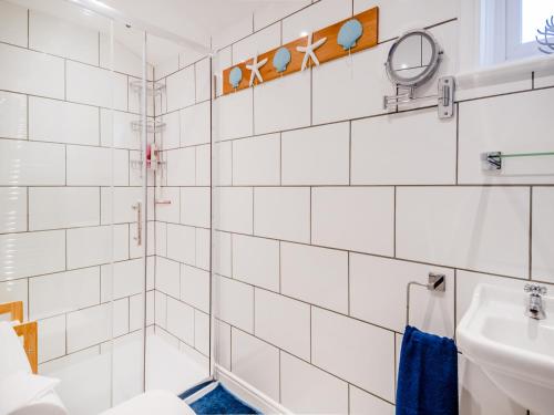 a bathroom with a shower and a sink at Beachcombers Retreat in Felixstowe