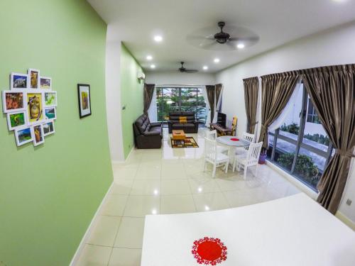 a living room with green walls and a table and chairs at Luxury Condominium at Loft Imago in Kota Kinabalu