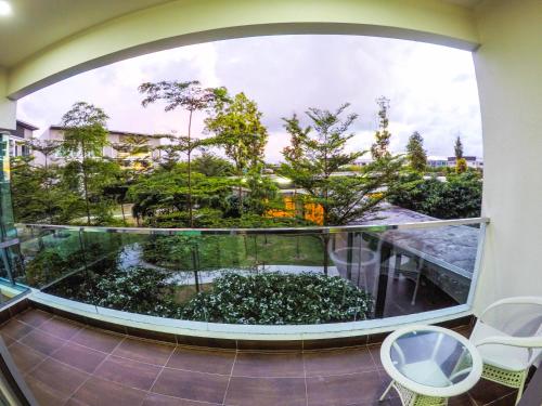 a room with a large window looking out at a garden at Luxury Condominium at Loft Imago in Kota Kinabalu