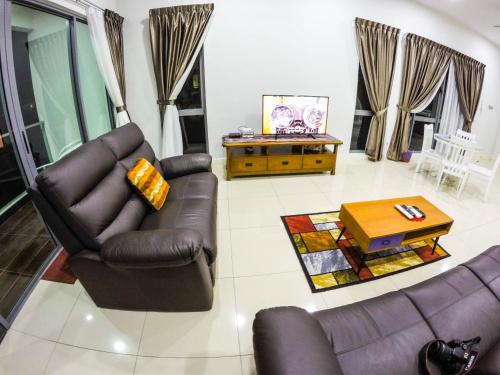 a living room with two couches and a coffee table at Luxury Condominium at Loft Imago in Kota Kinabalu