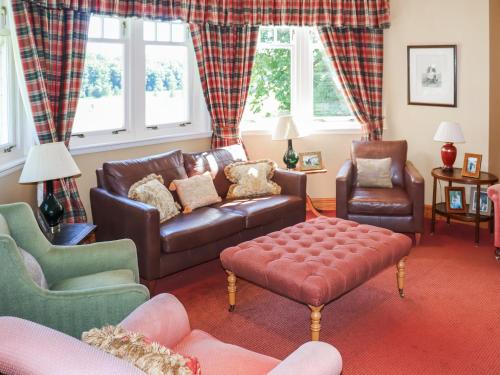 a living room with a leather couch and chairs at Hall Teasses Lodge - Uk52175 in Leven