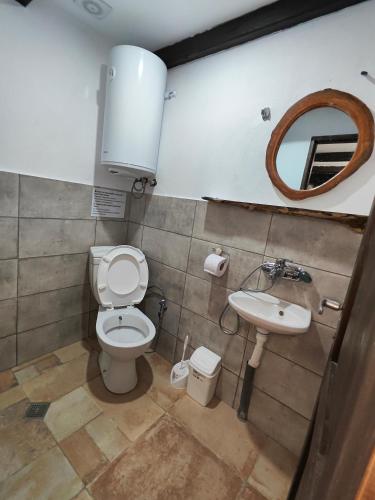 a bathroom with a toilet and a sink at Мехса in Svetoslav