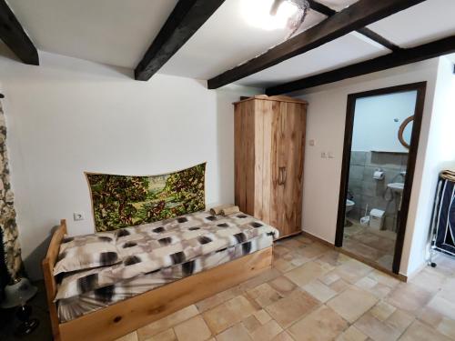 a bedroom with a bed and a sliding glass door at Мехса in Svetoslav