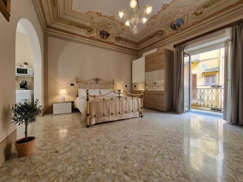 a large bedroom with a bed and a ceiling at Antica Dimora Donna Emma in Carini