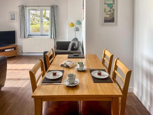 a dining room with a wooden table and chairs at Sunny Skies in St Austell