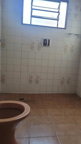 a bathroom with a toilet and a window at Entire house in Mococa