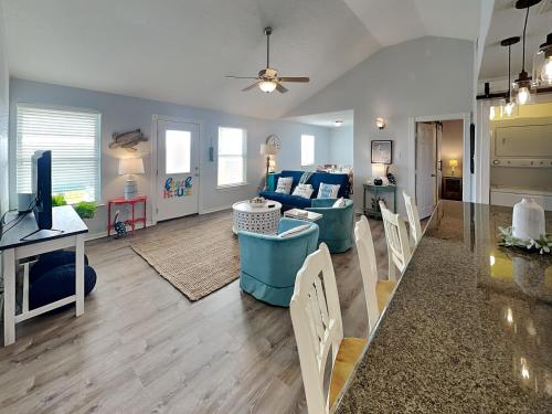 a living room with a couch and a tv at Beachy Keen in Surfside