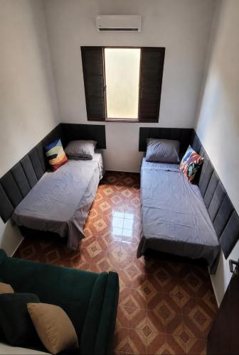 a small room with two beds and a couch at Entire house in Mococa