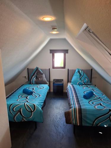 a room with two beds in a attic at GR ooms Rents in Gemmrigheim