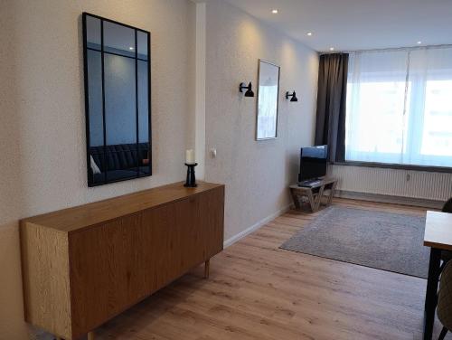 a living room with a fireplace and a television at Haus Schildt, FeWo 3 in Duhnen