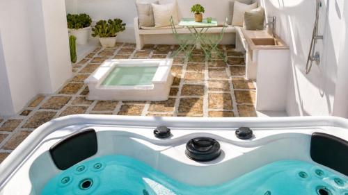 a bath tub in a bathroom with a tiled floor at 21mq Suite Jacuzzi in Ostuni