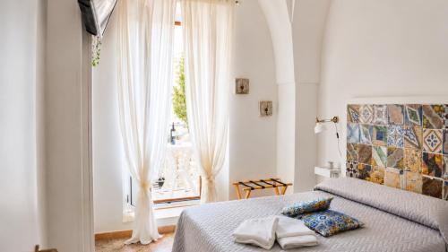 a bedroom with a bed and a large window at 21mq Suite Jacuzzi in Ostuni