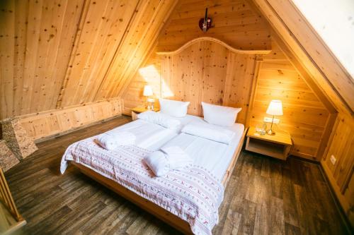 a bedroom with a large bed in a wooden room at Seehotel Burg Spreewald in Byhleguhrer Kaupen