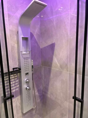 a walk in shower with a phone in a bathroom at Annaria in Leptokarya