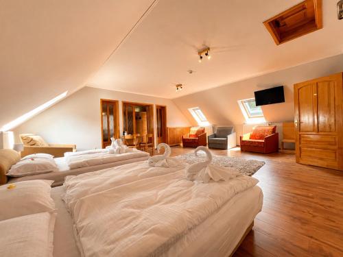 two swans are sitting on the beds in a room at Spring Apartments in Gheorgheni