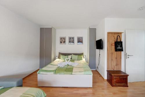 a bedroom with a bed with a bow on it at Schanzenblick mit Sauna und Pool in Schönwald
