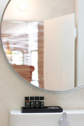 a mirror sitting on top of a bathroom sink at Quinta Do Miguel in Aldeia do Meco