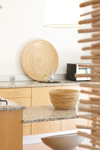a kitchen with a wooden bowl on a counter at Quinta Do Miguel in Aldeia do Meco