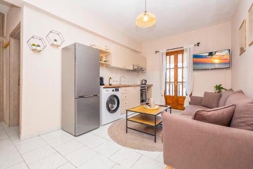 a kitchen and a living room with a refrigerator at Rocabella Home in Kriopigi