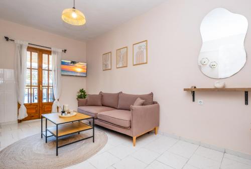 a living room with a couch and a table at Rocabella Home in Kriopigi
