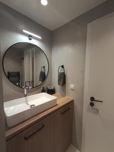 a bathroom with a sink and a mirror at IOVI Tinos II in Agios Sostis