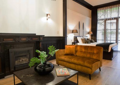 a living room with a bed and a couch and a chair at B in Antwerp in Antwerp