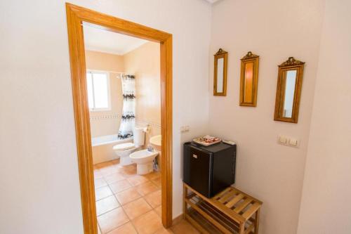 a bathroom with a toilet and a sink and a mirror at Oriheula Costa Cabo Roig 5 in Playas de Orihuela