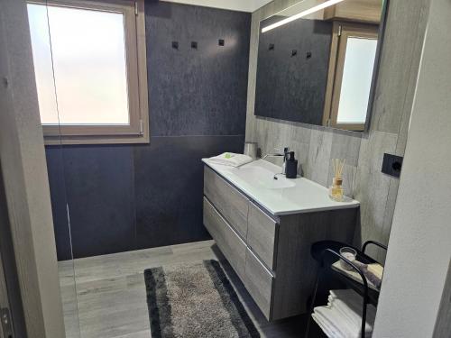 a bathroom with a sink and a mirror at EdenGHouse in Cordenons